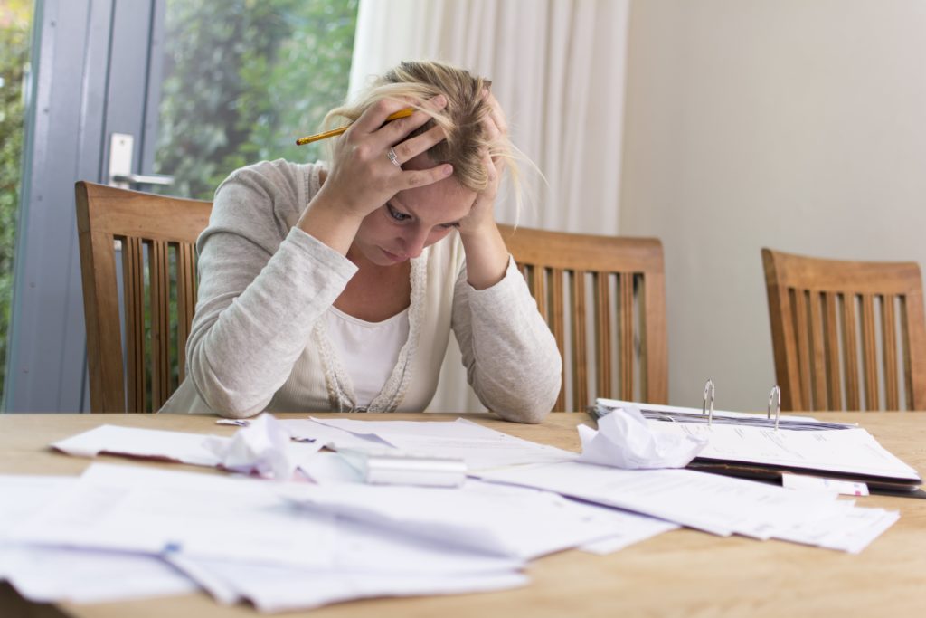 woman in stress facing IRS levy and wage garnishment