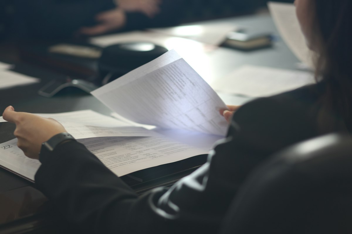Student reviewing financial aid paperwork at a table