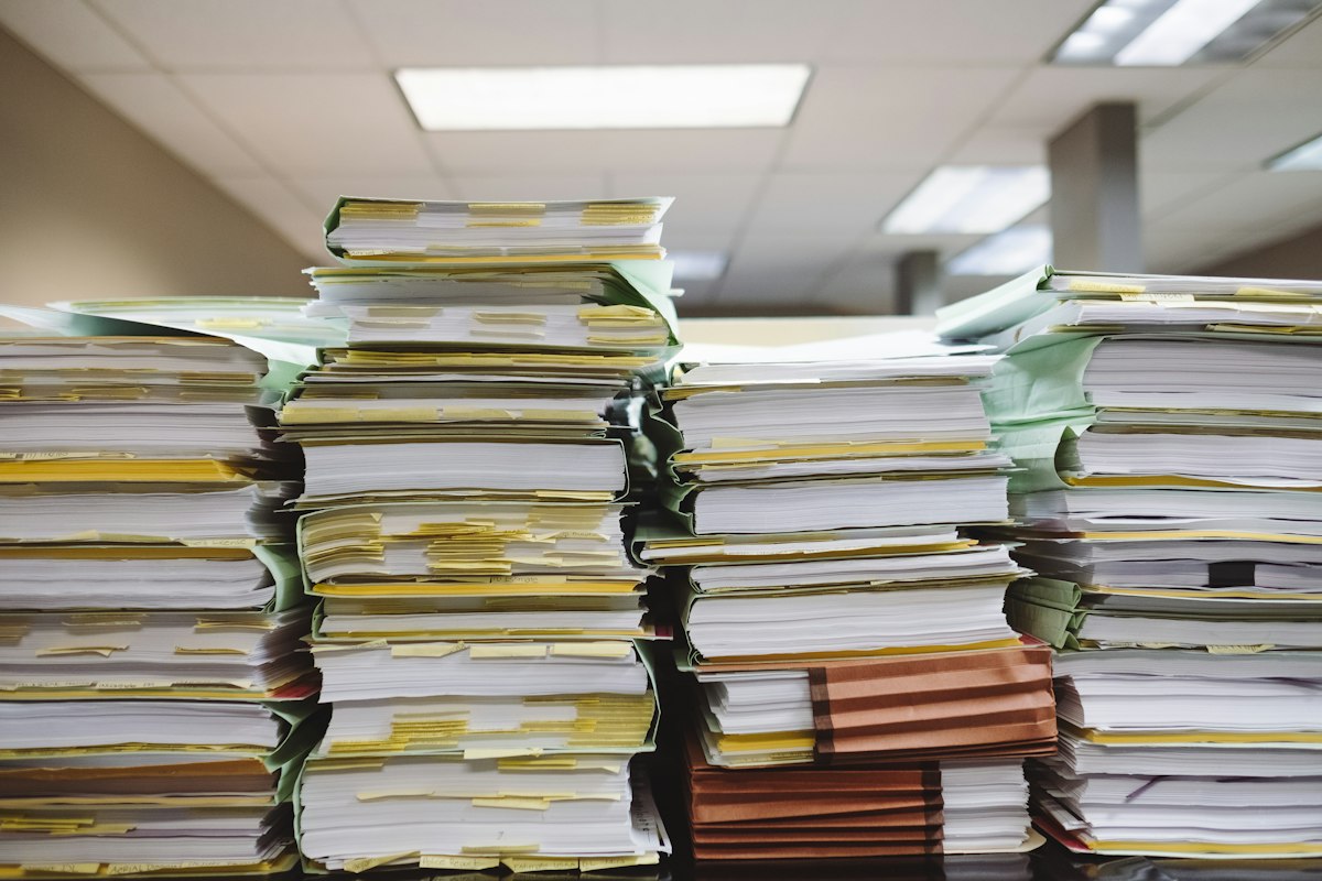 Stacks of old documents and file folders